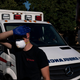 A paramedic shields his eyes while treating a man experiencing heat exposure during a heat wave, Saturday, June 26, 2021, in Salem, Oregon.